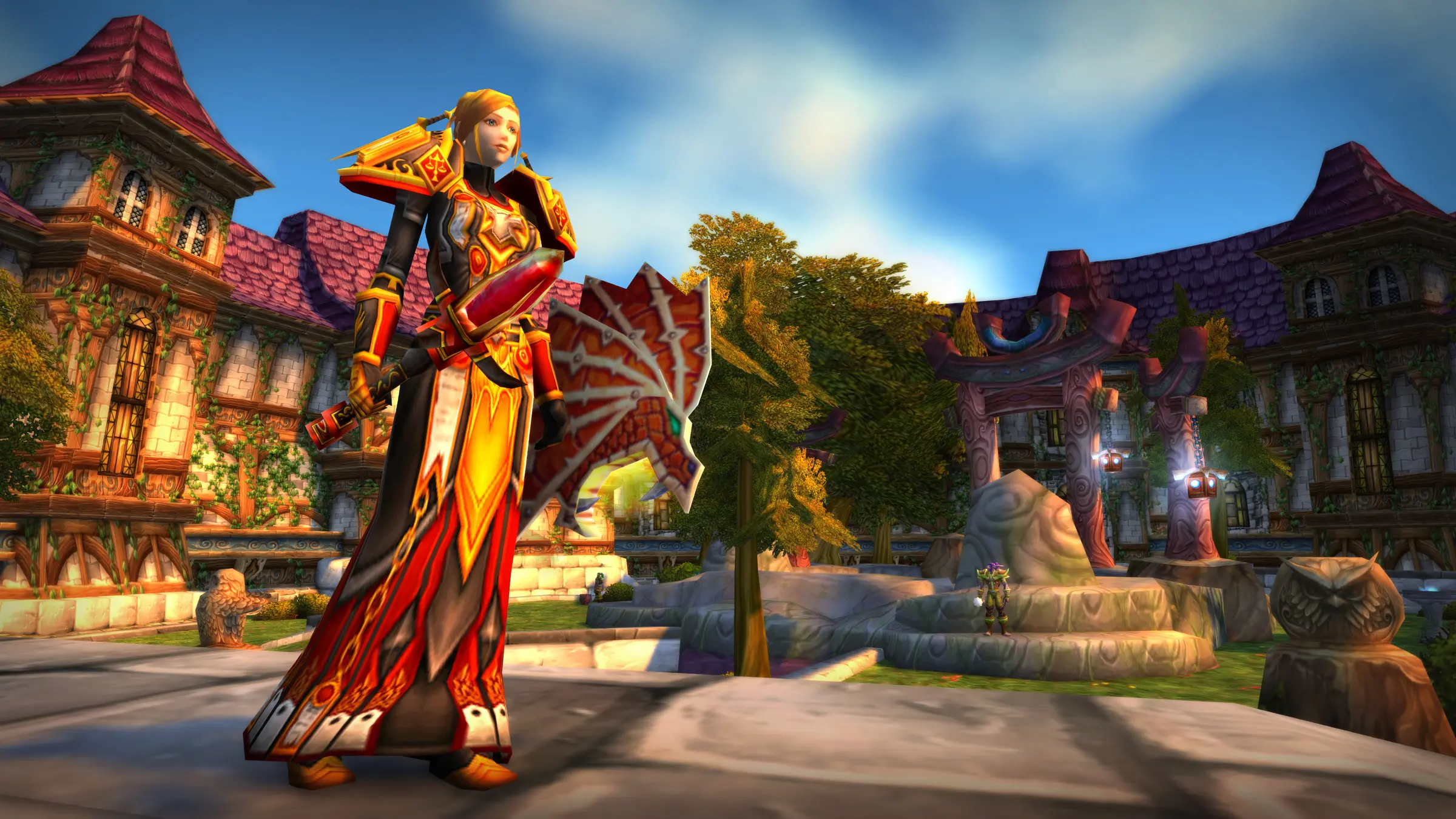 A human priest in crimson robes stands in a Stormwind square under a bright sky