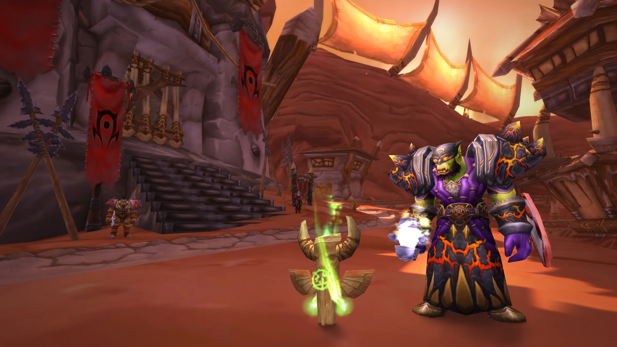 An orc warlock in fiery armour stands before the Horde banners of Orgrimmar