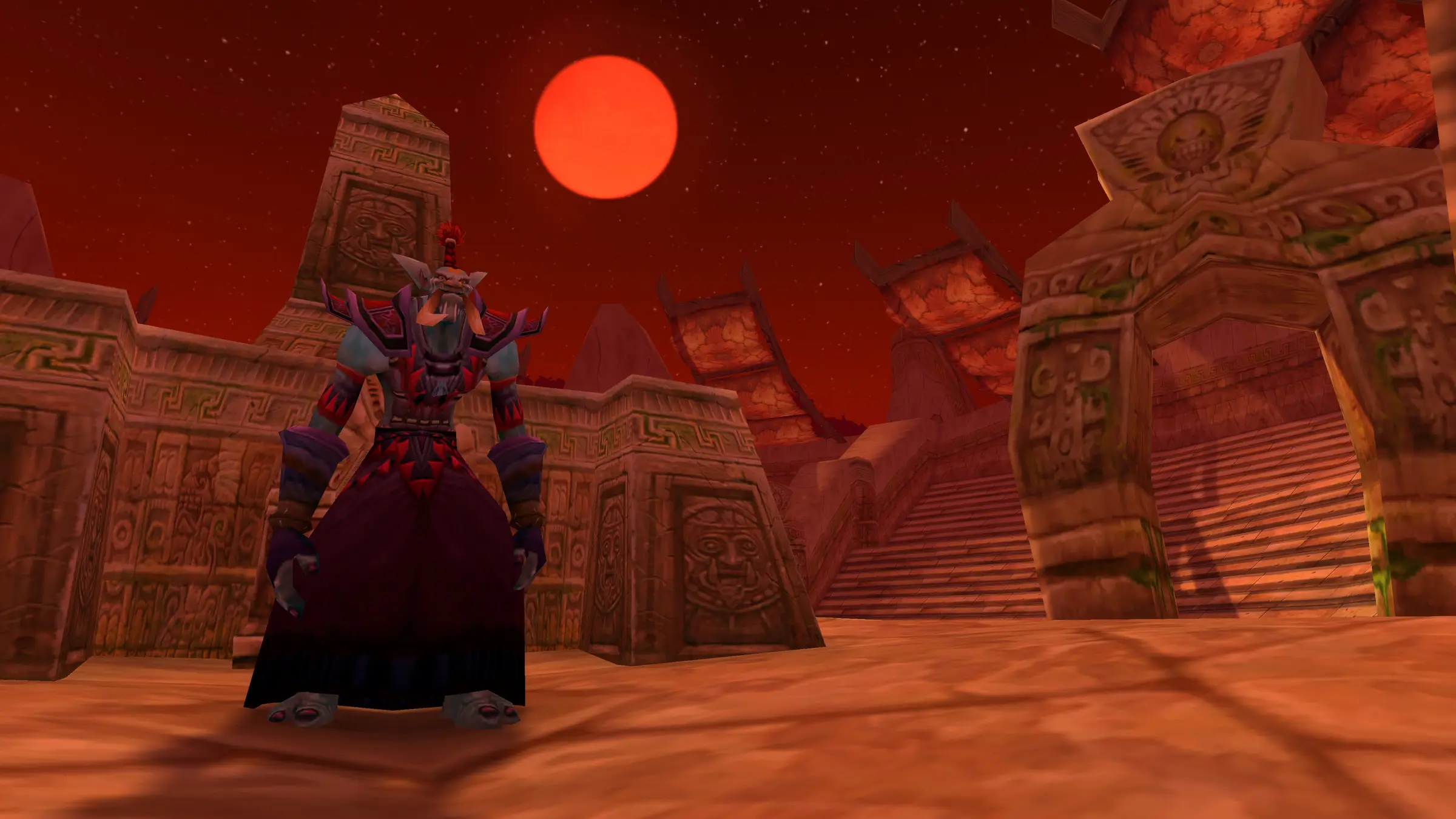 A troll in dark robes stands among carved stone ruins under a blood-red moon
